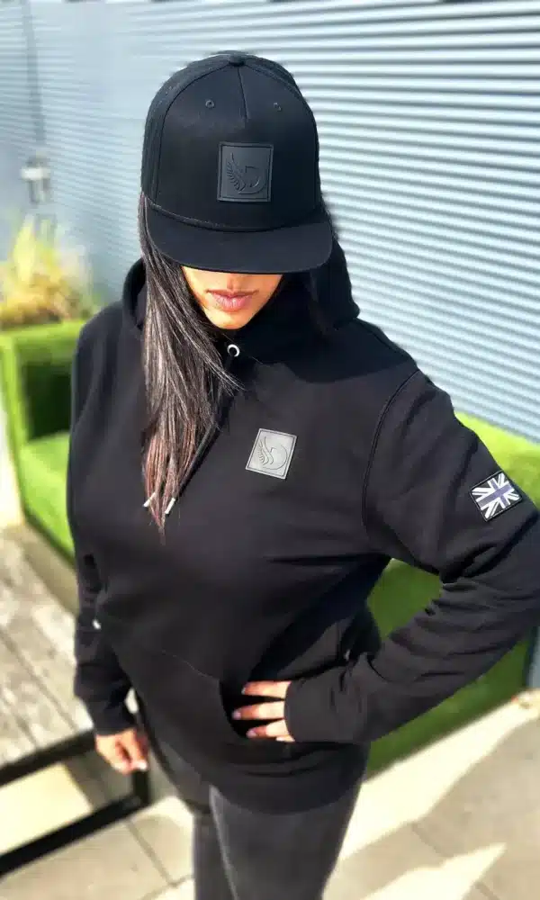 Woman wearing the DROW Wear AJ Stealth Hoodie with British military-inspired design.