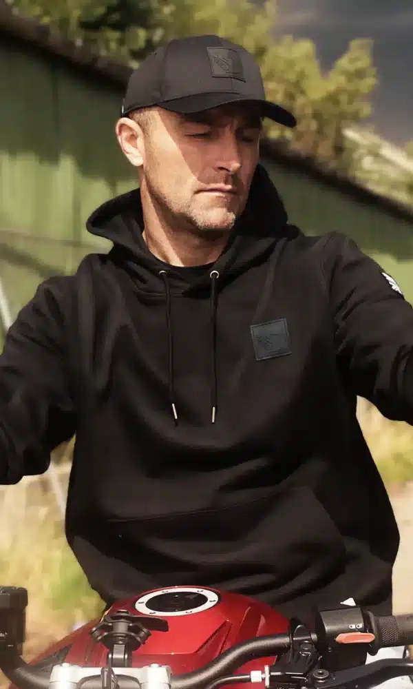 Biker wearing the DROW Wear AJ Stealth Hoodie with British military-inspired design.
