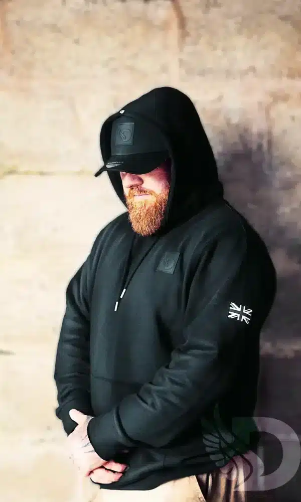 Man wearing DROW Wear AJ Stealth Hoodie with British military-inspired design.