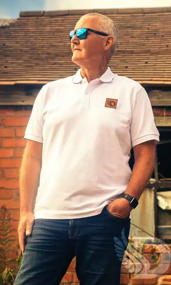 Man wearing white DROW Wear Heritage Polo with British military-inspired design.
