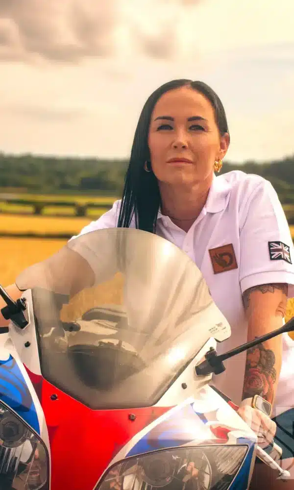 Woman wearing white DROW Wear Heritage Polo with British military-inspired design.