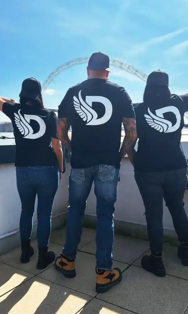 2 Women and 1 Man wearing the DROW Wear Big D T-Shirt Back View
