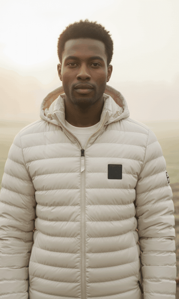 Front portrait of a man wearing the DROW Wear cream padded coat with military-inspired Union Jack patch.