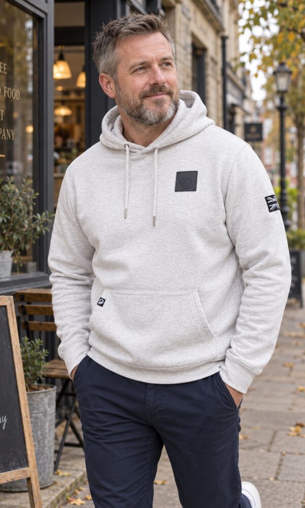 Male model wearing the Moonstone Hoodie outside a cafe, front view