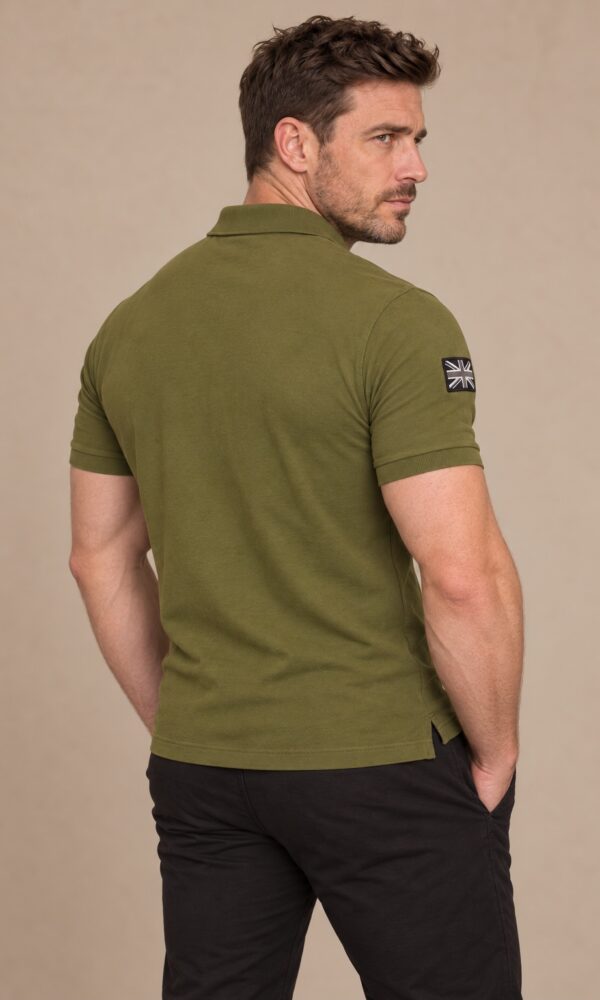 Muscular man wearing the DROW Khaki Field Polo, back studio view