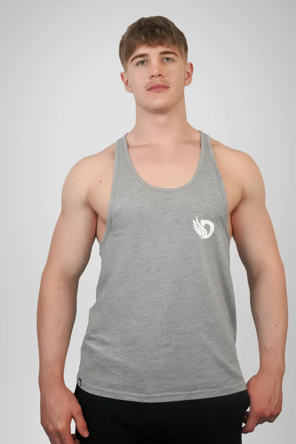 Front View of the DROW Outrider Grey Vest on a model with muscles