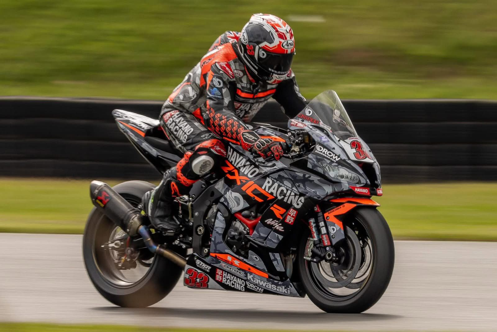 Hayano Racing motorcycle on track displaying DROW sponsorship branding