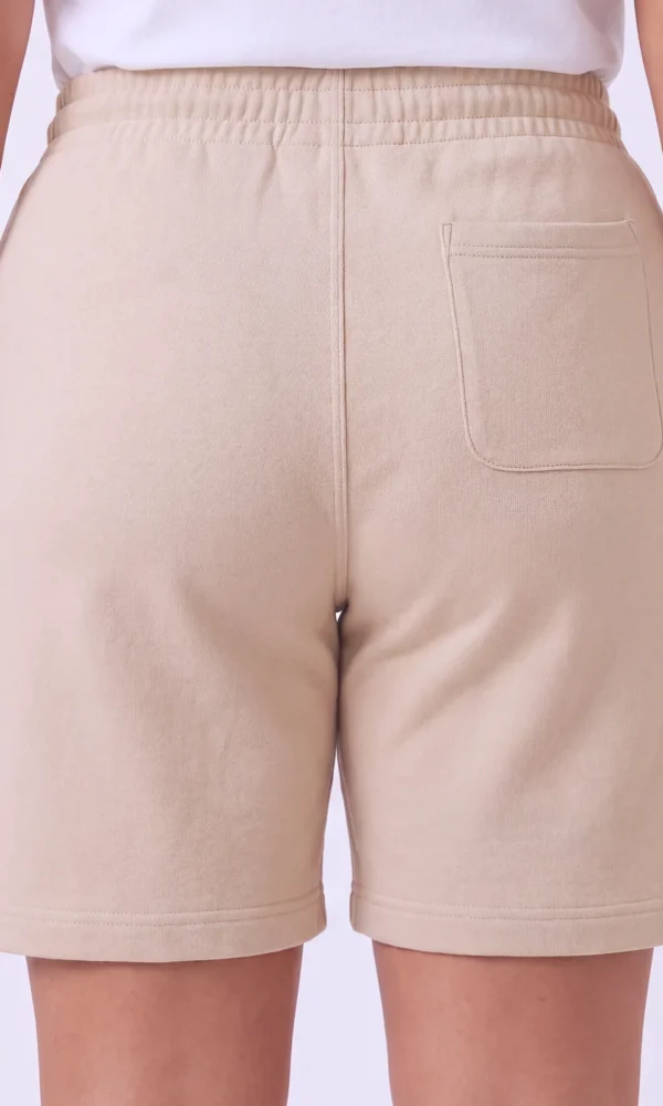 Back view of a woman wearing DROW Dust Premium Shorts showing the elasticated waist and rear patch pocket