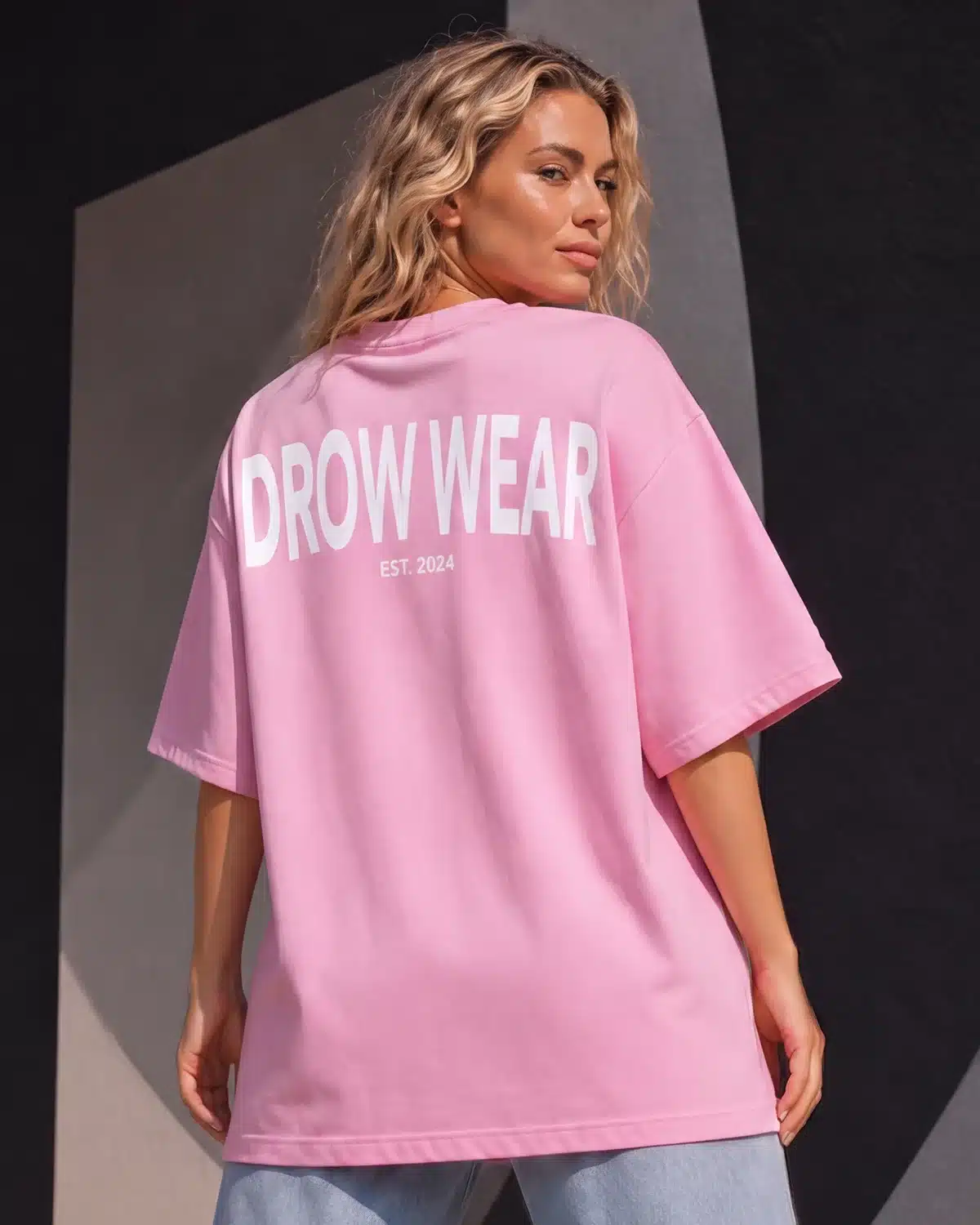 Full-length back view of woman wearing the Fearless Pink oversized boyfriend tee