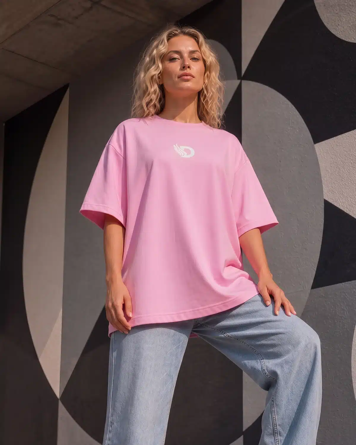 Full-length front view of woman wearing the Fearless Pink oversized boyfriend tee